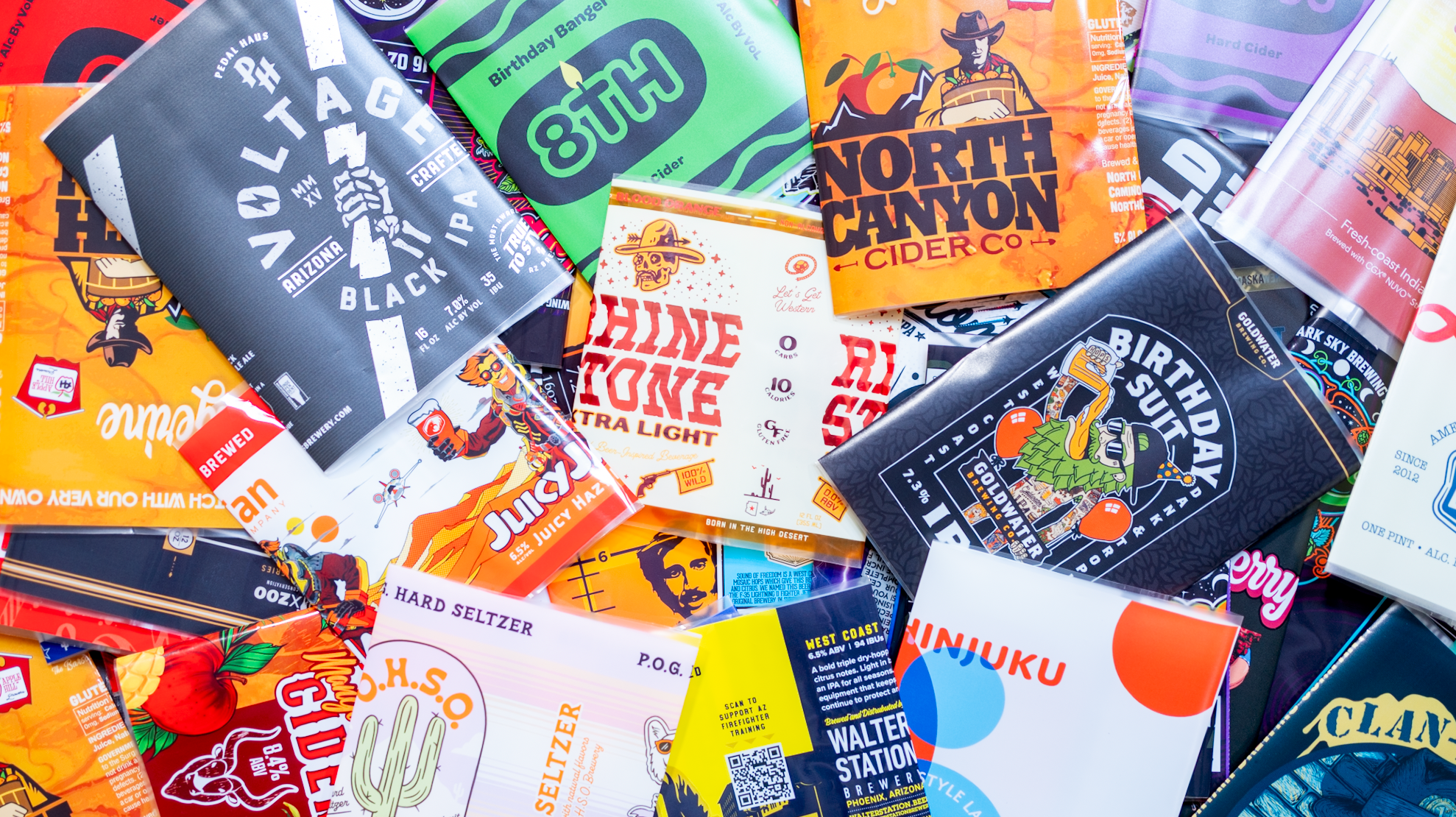 The Mangolorian craft beer can with a full-wrap custom label, flanked by collectible figures